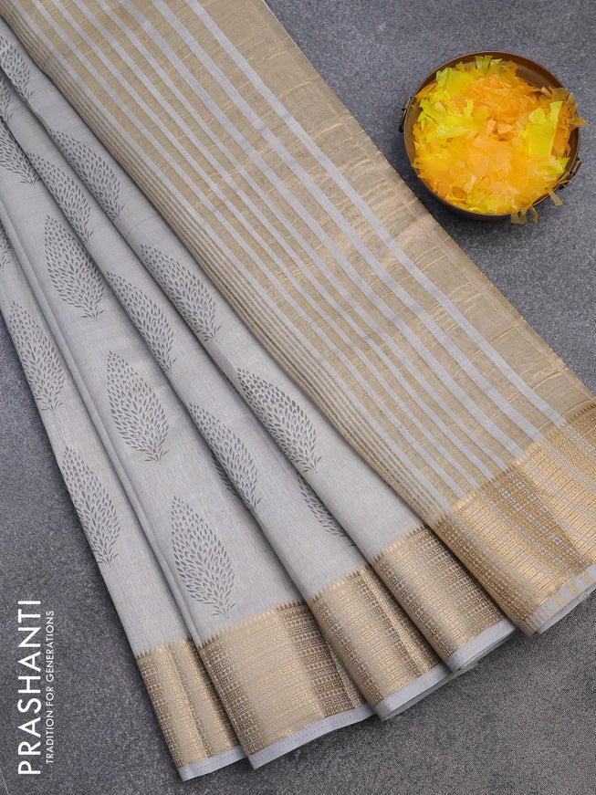 Semi raw silk saree pastel grey with allover leaf prints and zari woven border