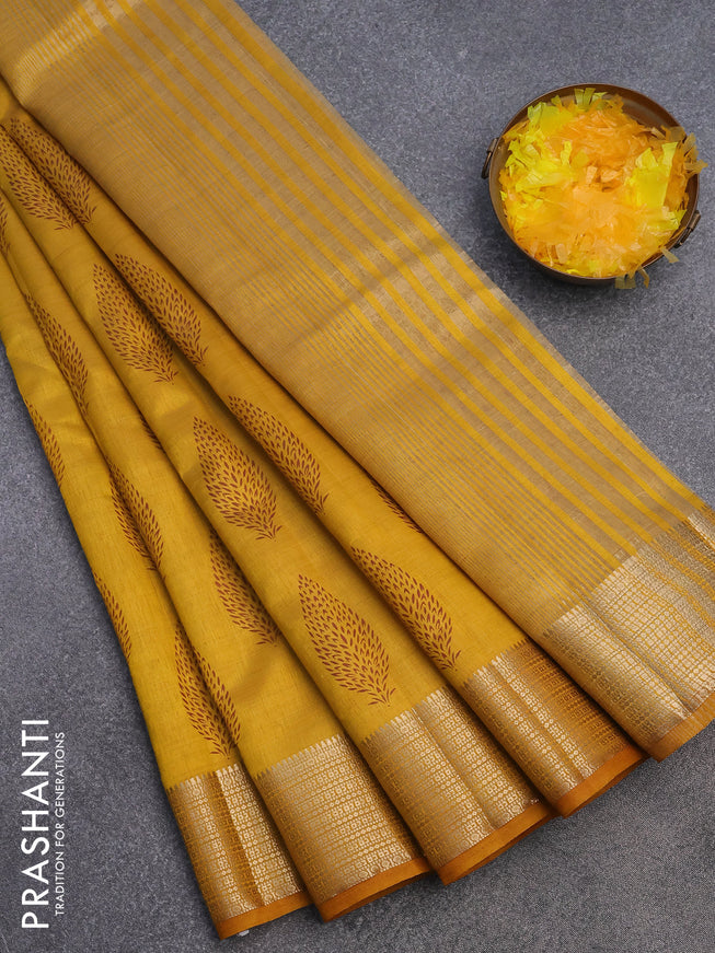 Semi raw silk saree mustard yellow with allover leaf prints and zari woven border