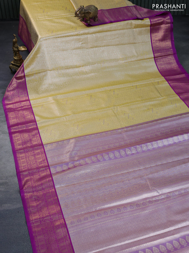 Tissue semi kanchipuram saree yellow and purple with allover zari woven brocade weaves and rich zari woven korvai border