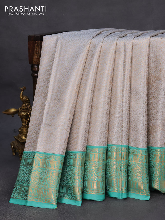 Tissue semi kanchipuram saree pastel grey and teal green shade with allover zari woven brocade weaves and rich zari woven korvai border