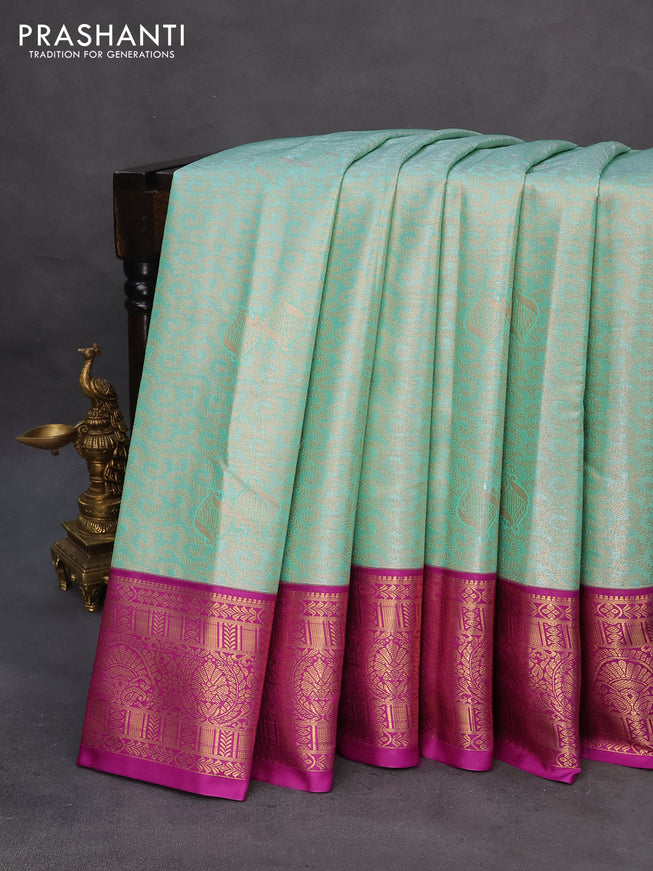 Tissue semi kanchipuram saree teal green shade and purple with allover zari woven brocade weaves and zari woven korvai border