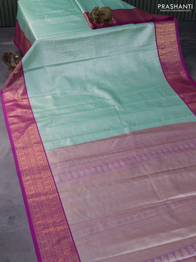 Tissue semi kanchipuram saree teal green shade and purple with allover zari woven brocade weaves and zari woven korvai border