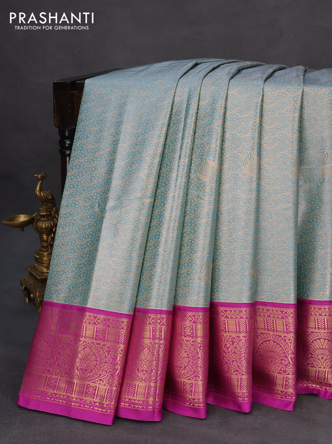 Tissue semi kanchipuram saree teal blue and purple with allover zari woven brocade weaves and zari woven korvai border