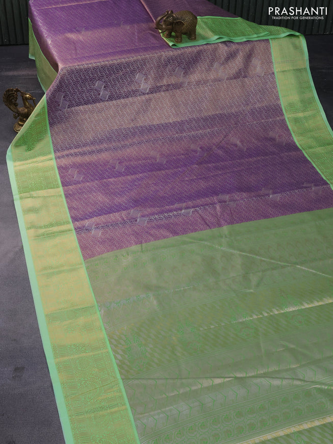 Tissue semi kanchipuram saree lavender and teal green shade with allover silver zari woven brocade weaves and zari woven korvai border