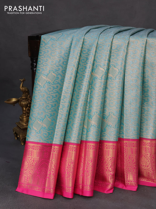 Tissue semi kanchipuram saree teal green and pink with allover zari woven brocade weaves and rich zari woven korvai border