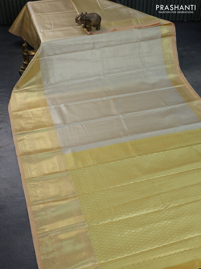 Tissue semi kanchipuram saree mustard shade and sandal with allover zari woven brocade weaves and long zari woven border