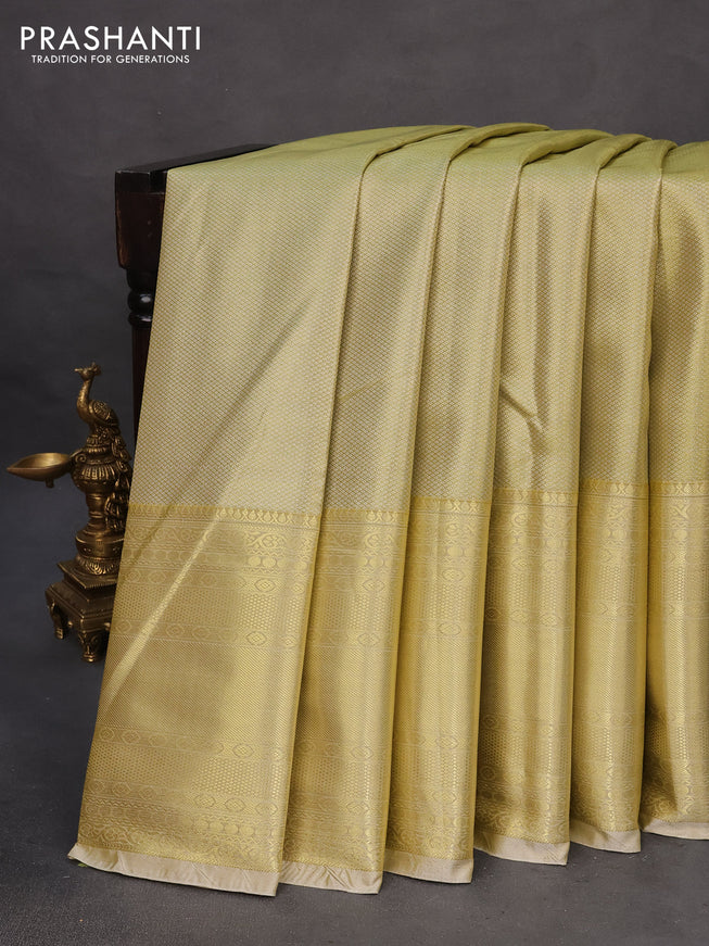 Tissue semi kanchipuram saree lime shade and beige with allover silver zari woven brocade weaves and long zari woven border