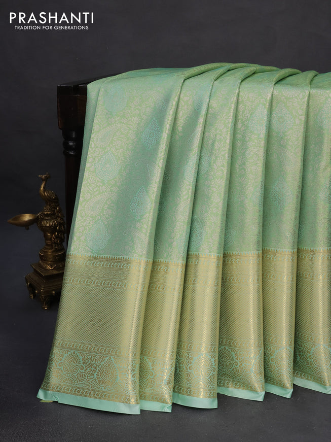 Tissue semi kanchipuram saree teal green shade with allover silver zari woven brocade weaves and long zari woven border