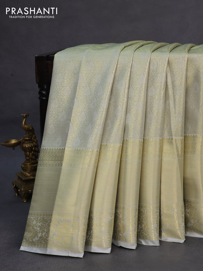 Tissue semi kanchipuram saree dual shade of pastel grey with allover zari woven brocade weaves and long zari woven border