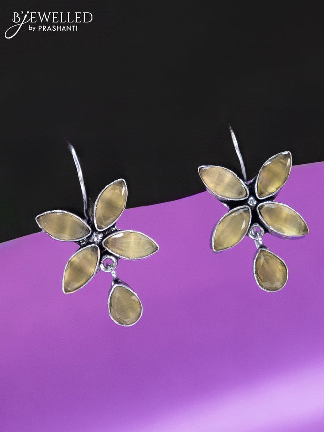 Oxidised hanging type earring with yellow stones