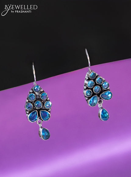 Oxidised hanging type earring with ice blue stones