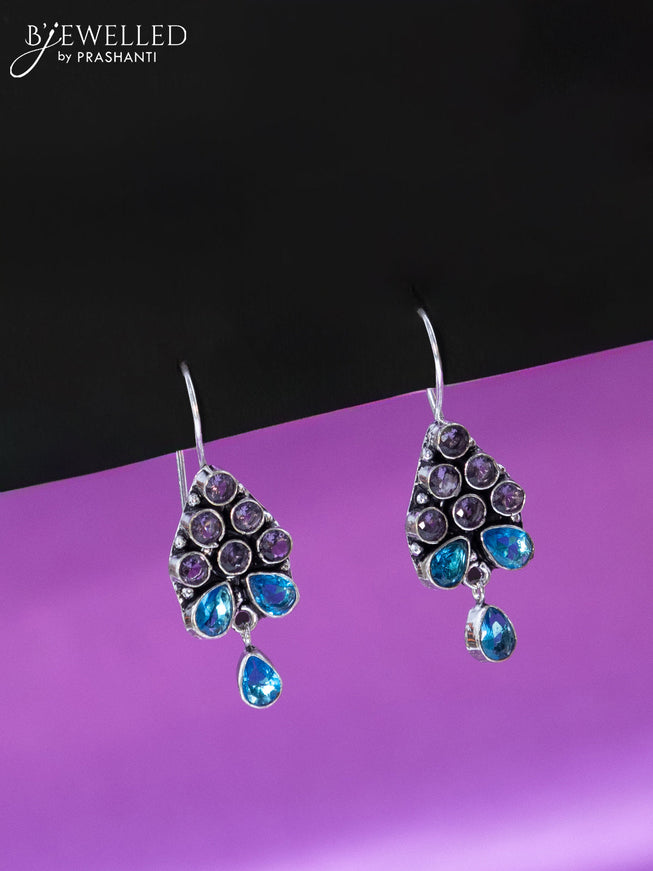 Oxidised hanging type earring with violet and ice blue stones