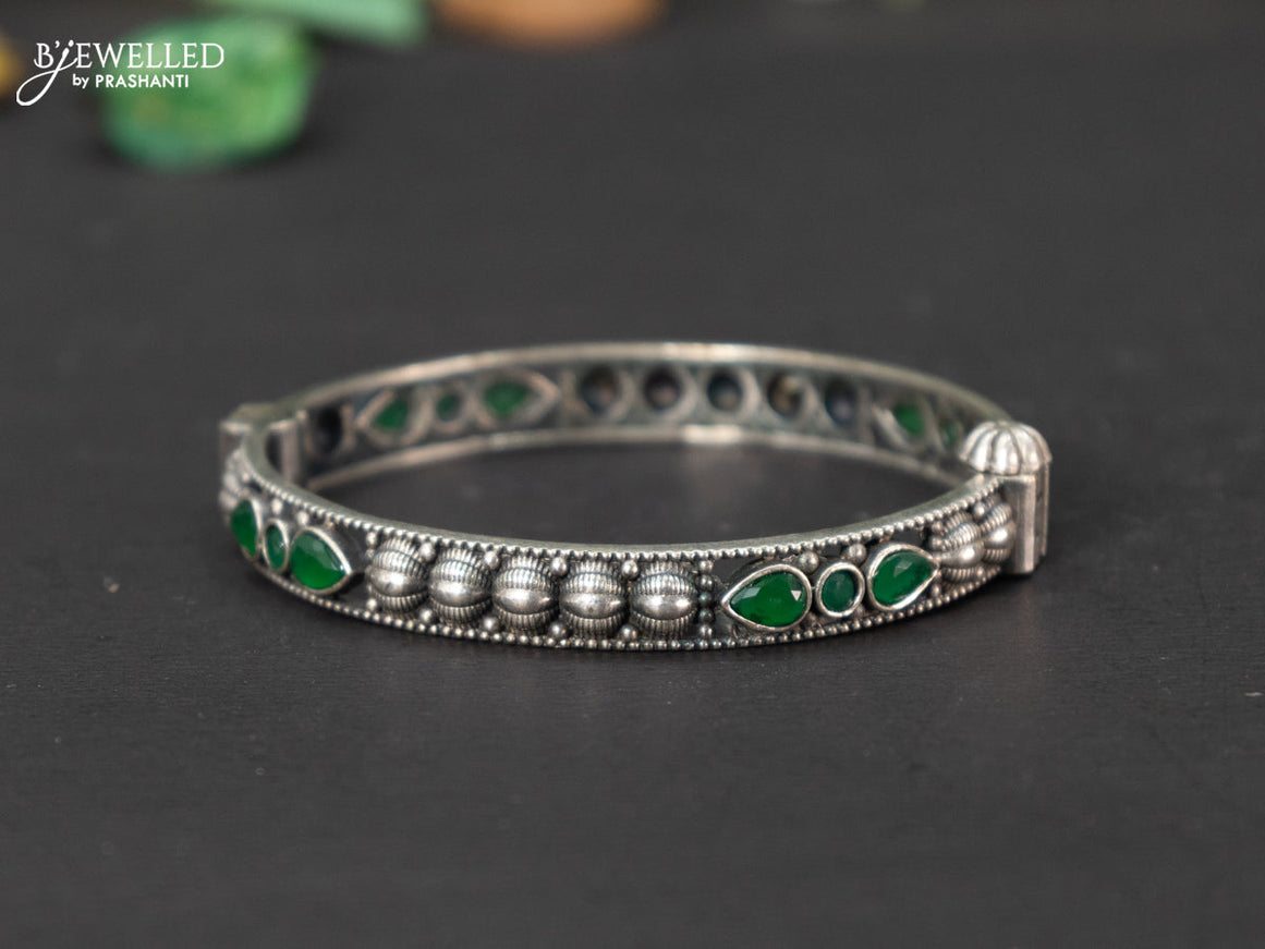 Oxidised screw type bangle with emerald stones