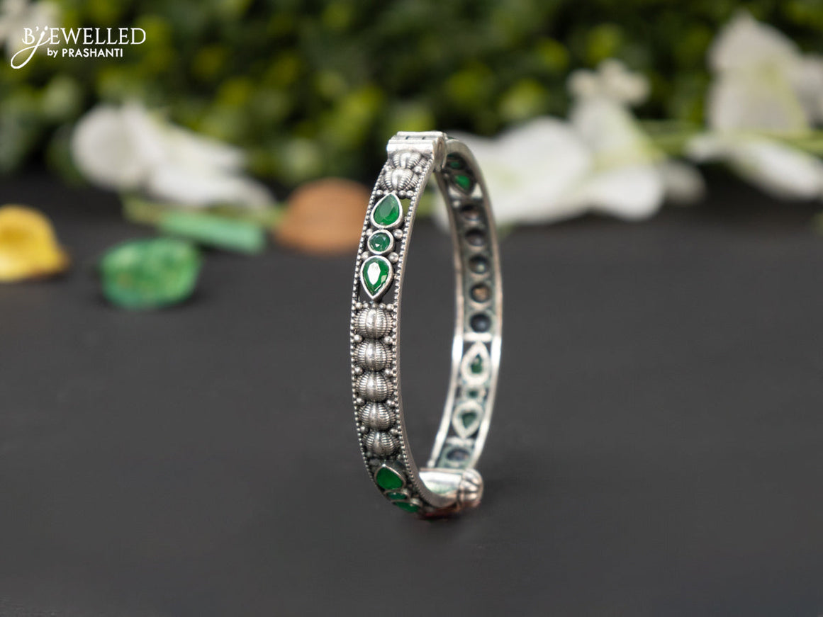 Oxidised screw type bangle with emerald stones