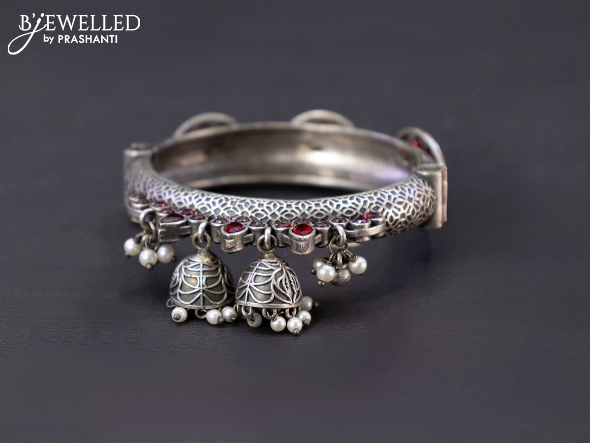 Oxidised screw type bangle with ruby stones and hangings