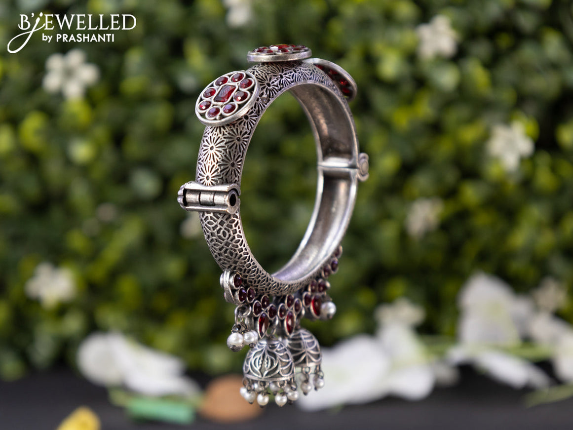 Oxidised screw type bangle with ruby stones and hangings