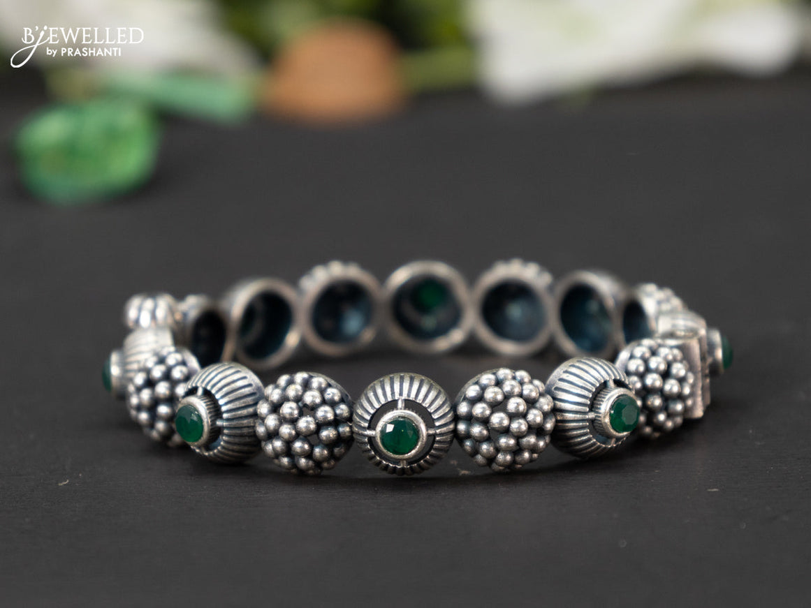 Oxidised screw type bangle with emerald stones