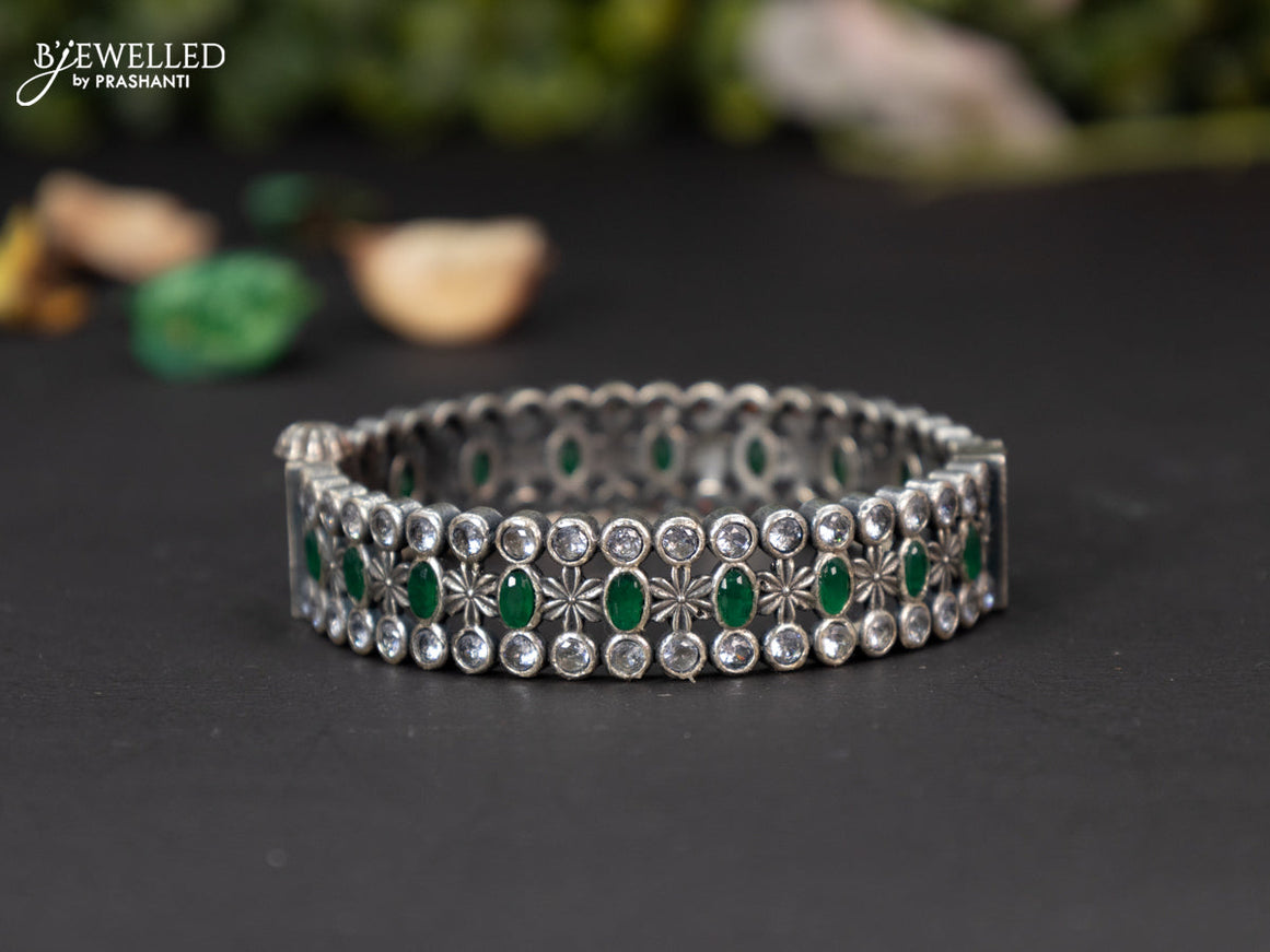 Oxidised screw type bangle with emerald and cz stones