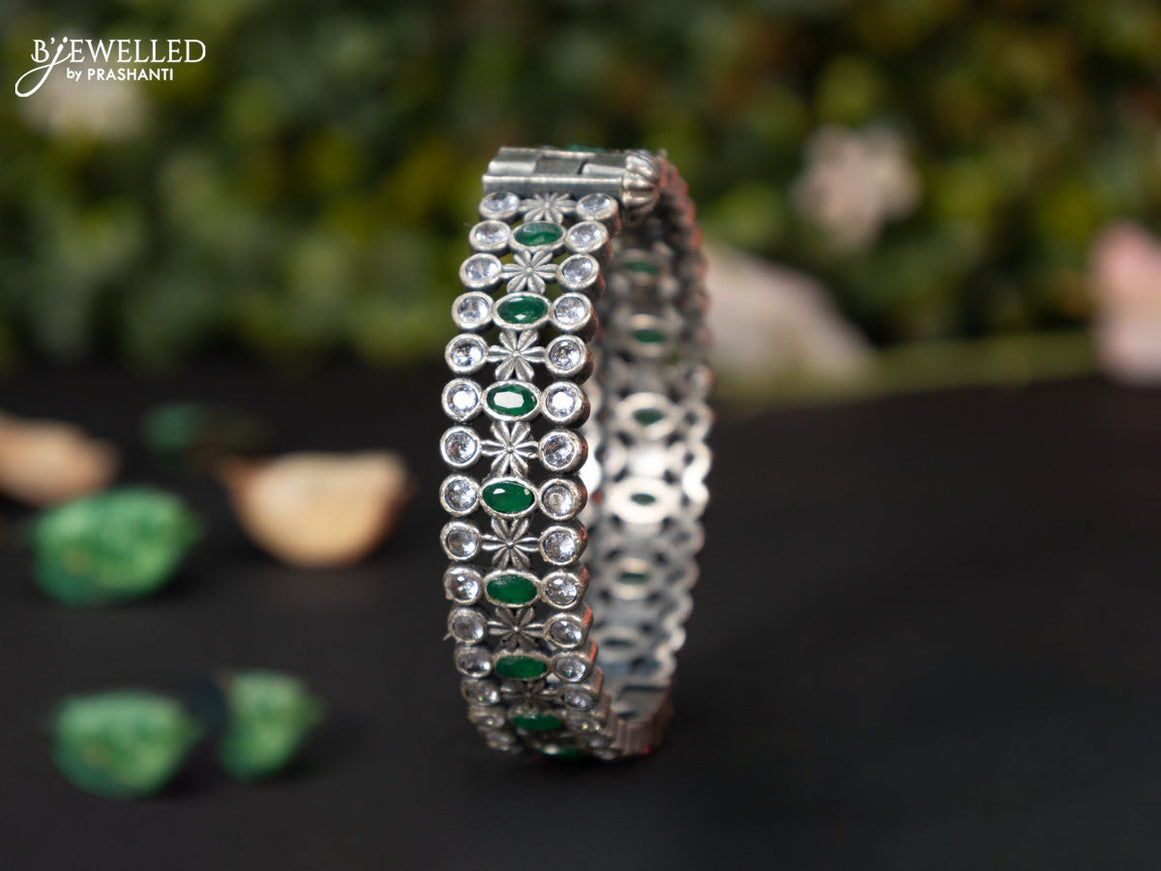 Oxidised screw type bangle with emerald and cz stones