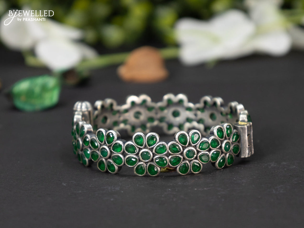 Oxidised screw type bangle floral design with emerald stones