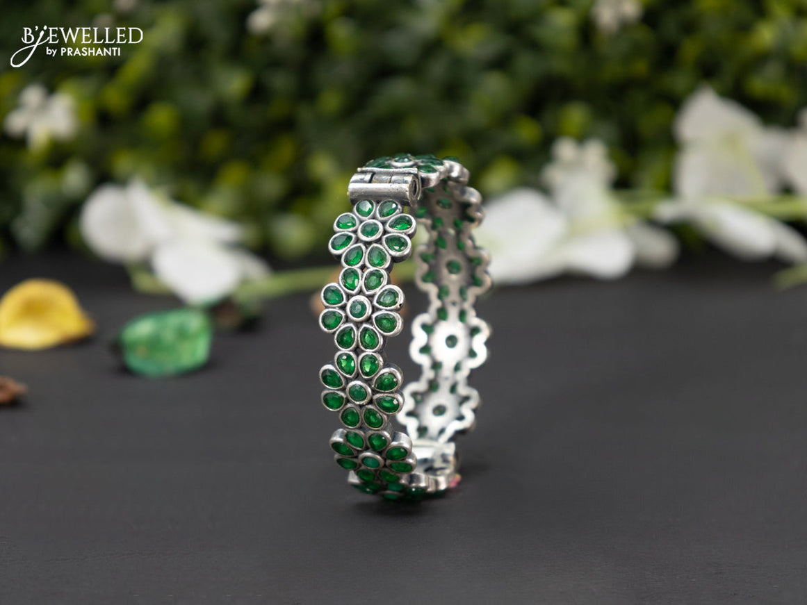 Oxidised screw type bangle floral design with emerald stones