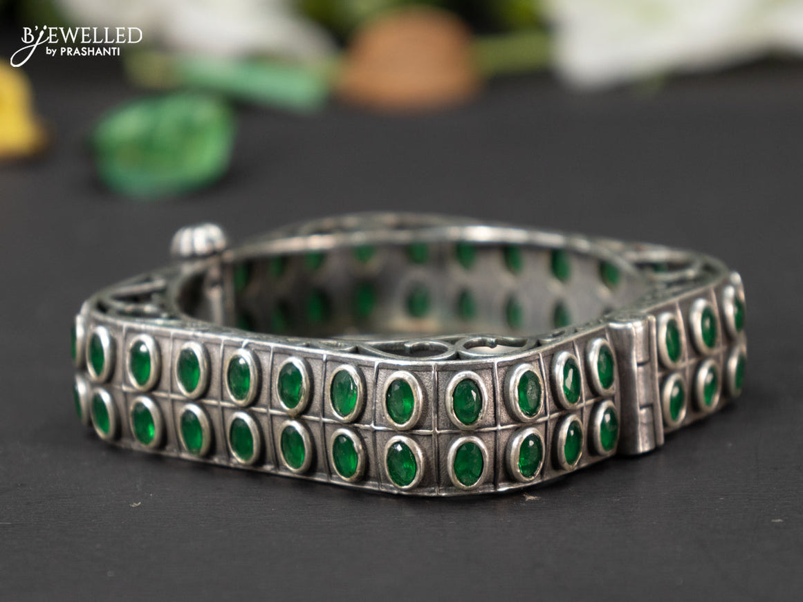 Oxidised screw type bangle with emerald stones