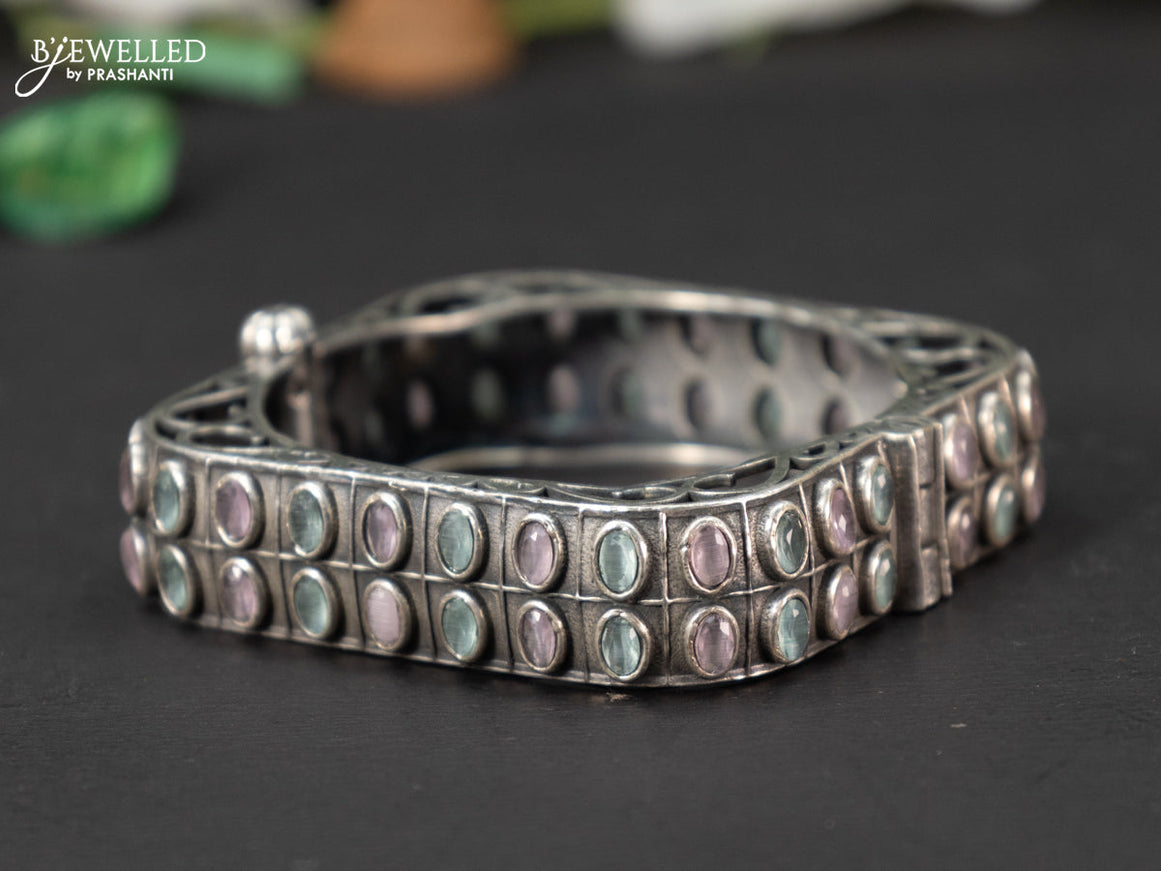 Oxidised screw type bangle with mint green and baby pink stones