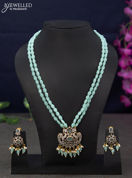 Beaded double layer mint green necklace peacock design with cz stones and beads hanging in victorian finish