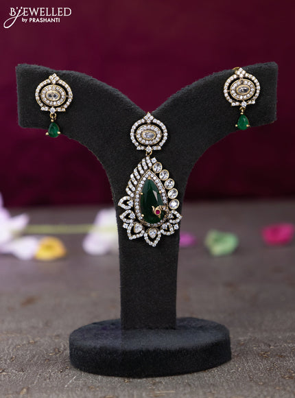 Victorian finish pendant set with emerald and cz stones