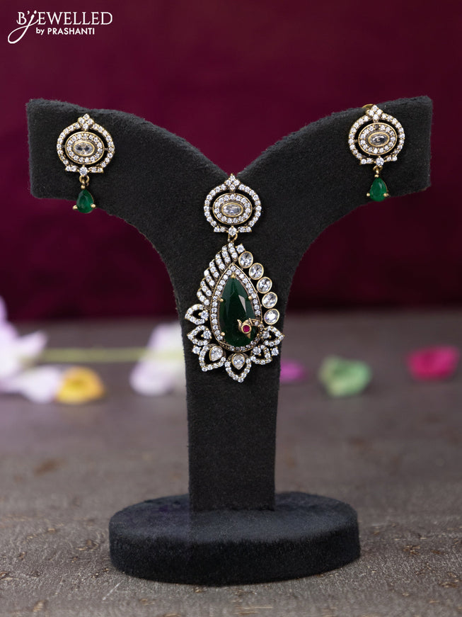 Victorian finish pendant set with emerald and cz stones