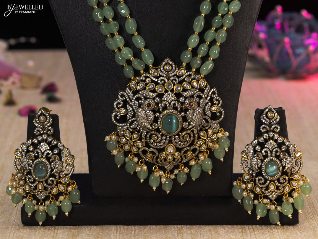 Beaded mint green necklace parrot design with cz stones and beads hanging in victorian finish