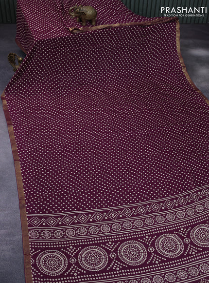 Semi georgette saree purple with allover bandhani prints and zari woven border