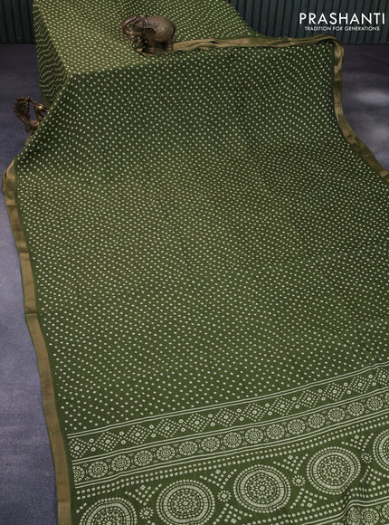 Semi georgette saree sap green with allover bandhani prints and zari woven border