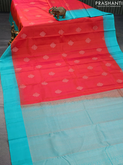 Pure kanchipuram silk saree dual shade of pinkish orange and teal green with zari woven buttas and simple border