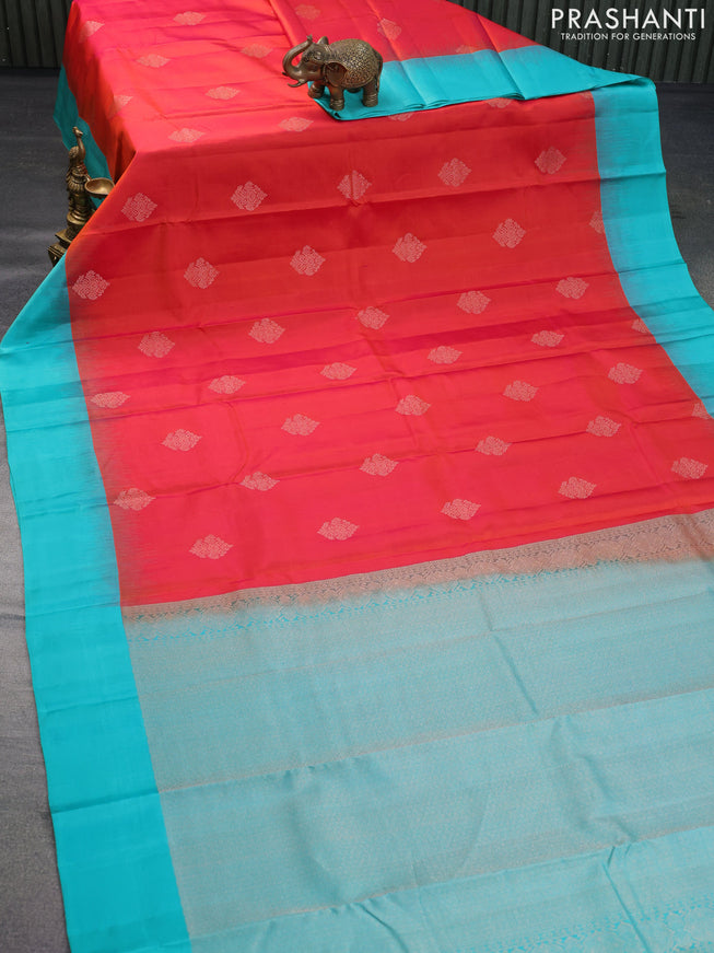 Pure kanchipuram silk saree dual shade of pinkish orange and teal green with zari woven buttas and simple border