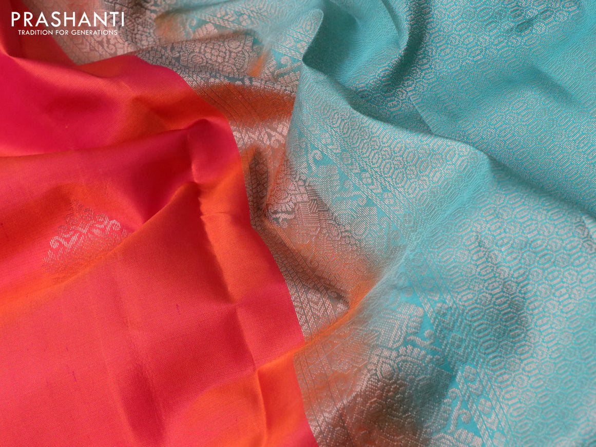 Pure kanchipuram silk saree dual shade of pinkish orange and teal green with zari woven buttas and simple border