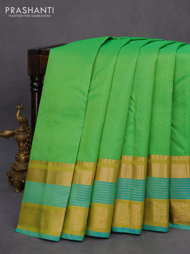 Pure kanchipuram silk saree green and dual shade of blue with allover zari woven stripe pattern and long rich zari woven border