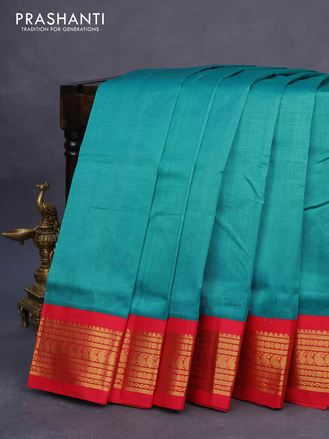 Silk cotton saree teal blue shade and red with plain body and zari woven korvai border