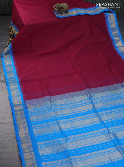 Silk cotton saree maroon and cs blue with plain body and zari woven korvai border