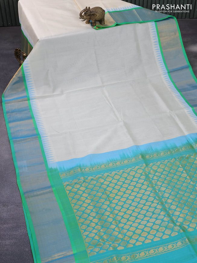 Kuppadam silk cotton saree cream and dual shade of teal bluish green with plain body and temple design zari woven border