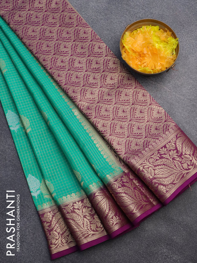 Semi crepe saree teal green and purple with allover zari checks & buttas and zari woven border