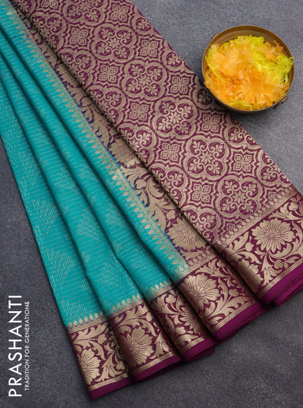 Semi crepe saree teal blue and purple with allover zari weaves and zari woven border