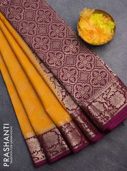 Semi crepe saree mango yellow and purple with allover zari weaves and zari woven border