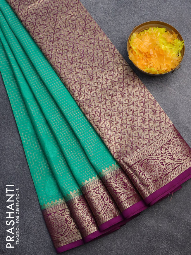 Semi crepe saree teal green and purple with allover zari checks & self emboss butta and zari woven border