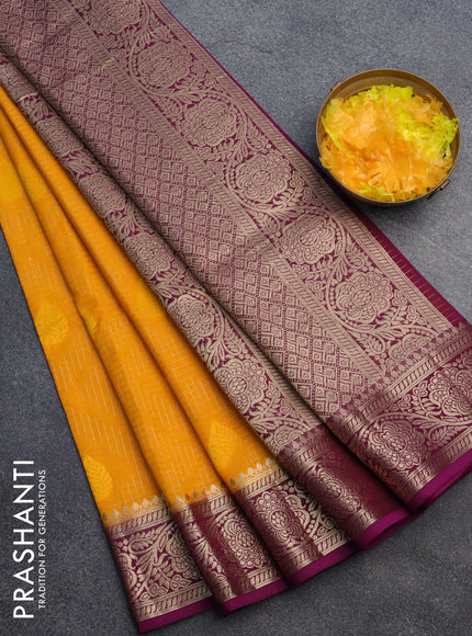 Semi crepe saree mango yellow and purple with allover zari checks & self emboss butta and zari woven border