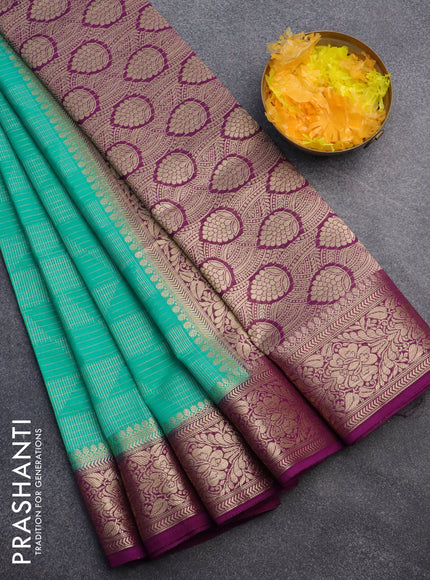 Semi crepe saree teal green and deep purple with allover geometric zari weaves & self emboss and zari woven border