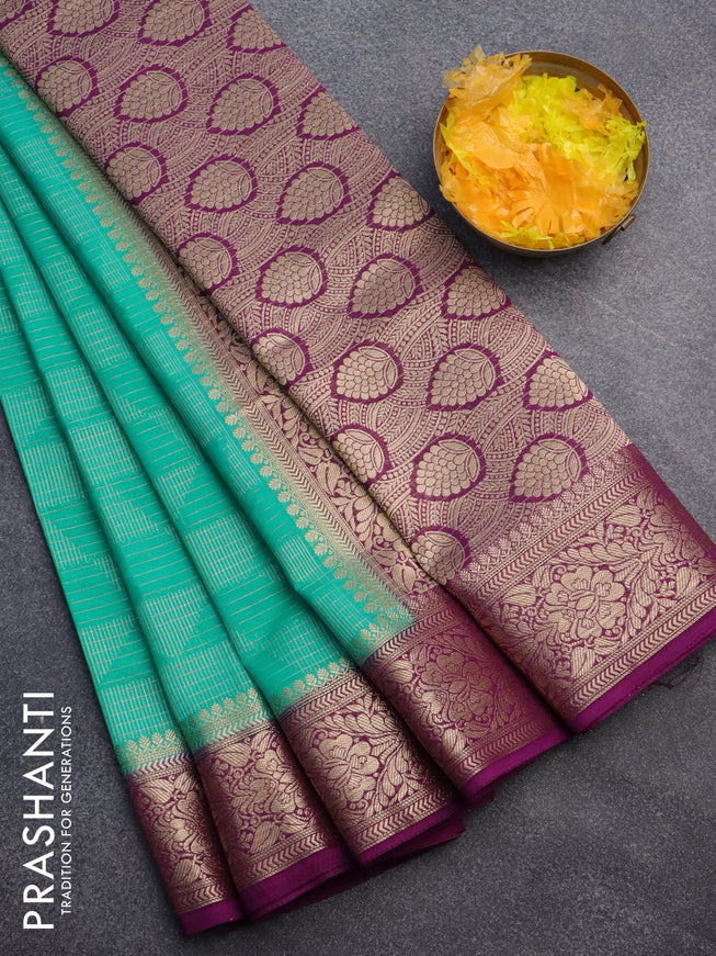 Semi crepe saree teal green and deep purple with allover geometric zari weaves & self emboss and zari woven border