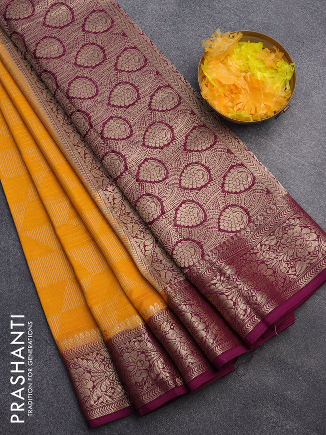 Semi crepe saree mango yellow and purple with allover geometric zari weaves & self emboss and zari woven border