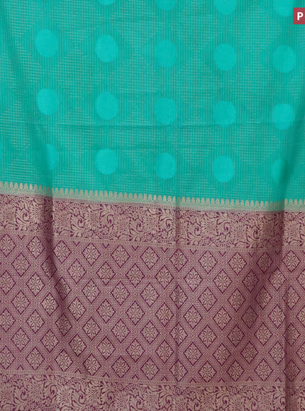 Semi crepe saree teal green and purple with allover geometric zari weaves & self emboss and zari woven border