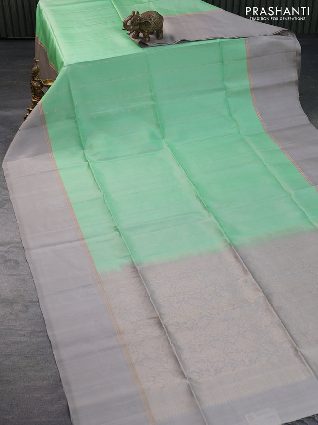 Pure soft silk saree pastel green and grey with allover zari woven buttas and zari woven simple border